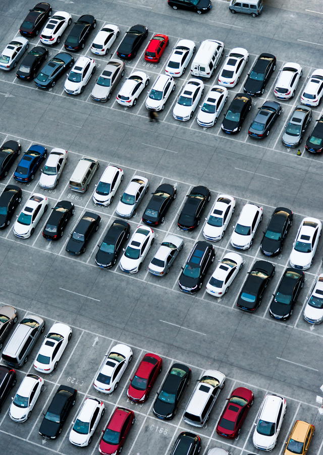 Fleet vehicles in organized parking spaces